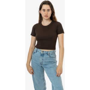 A mid-length baby rib crewneck tee in brown, worn with light blue jeans. The model poses against a plain background.