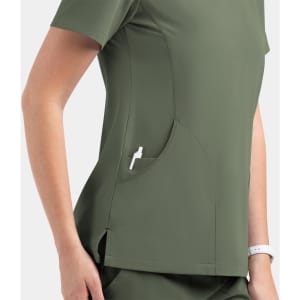 A women's V-neck top in olive green with a side pocket and a logo. The fabric appears smooth and fitted.