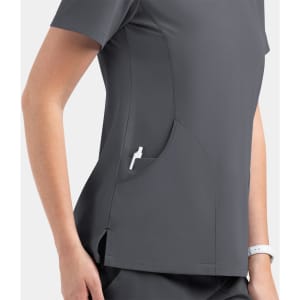 A women's dark grey V-neck top featuring side pockets and a casual fit. Includes branding on the design.