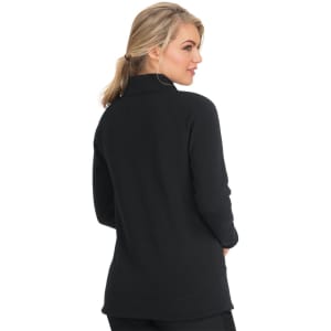 A woman wearing a black wellness jacket, viewed from the back, featuring a high collar and long sleeves.
