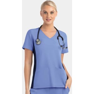 A mock wrap top in light blue with contrast navy panels and a pocket, featuring a stethoscope around the model's neck.