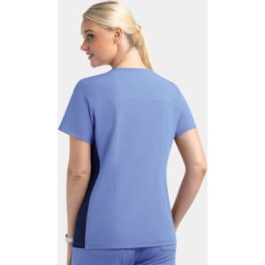 A women's mock wrap top in light blue with contrast navy panels and a logo.