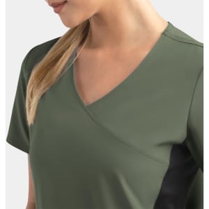 A women's mock wrap top in olive green with contrast panels, featuring a v-neck design. It includes a logo.