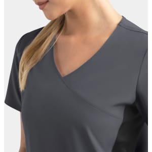 A mock wrap top in dark grey, featuring contrast panels on the sides and a V-neck design. It has a logo.