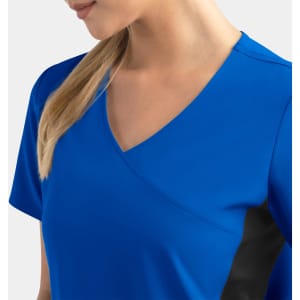 A blue mock wrap top features contrast black panels on the sides, designed for women.