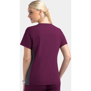 A mock wrap top in plum with grey contrast panels, featuring a logo. Designed for women, back view shown.
