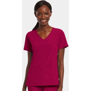 A mock wrap top in a rich fuchsia colour featuring short sleeves and front pockets. It has a logo on it.