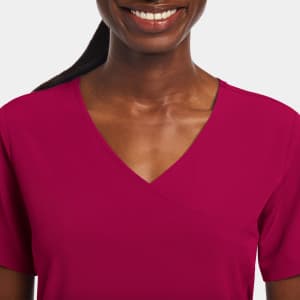 A women's mock wrap top in a vibrant magenta colour, featuring a V-neckline and a fitted design.