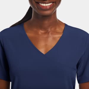 A navy women's mock wrap top with short sleeves and a v-neckline, featuring a logo on the garment.