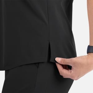 A close-up of a black women's V-neck top, featuring a tuckable design and side slit detail.