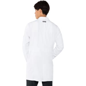 A white lab coat displayed on a model facing away, featuring a streamlined design and a logo on the back.
