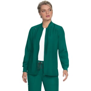 A green jacket with a high collar and long sleeves, featuring a logo. The model wears it over a white top.