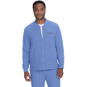 A man wearing a light blue jacket with a zip and one unobtrusive logo on the chest.