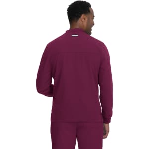 A man wearing a maroon jacket, viewed from the back, with a logo displayed on the upper back.
