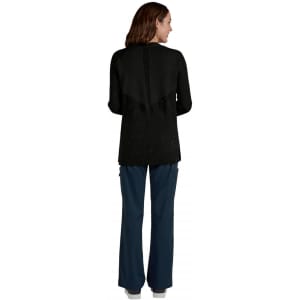 A black Kori Sweater being worn from the back, paired with navy blue trousers. The garment features a textured design and has a logo.