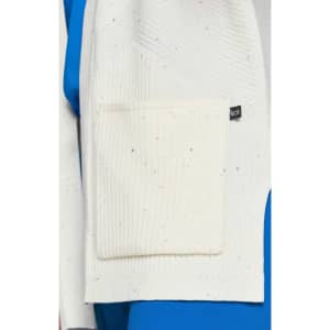 A white Kori sweater with a textured pattern and a pocket, featuring multicoloured specks on the fabric.