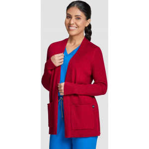 A red Kori Sweater with a relaxed fit, featuring pockets and a woman wearing it, styled with a blue outfit.