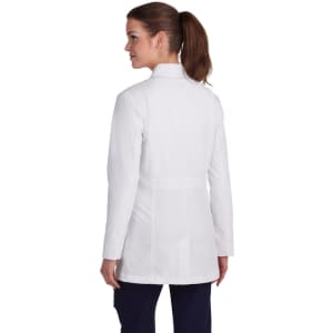 A woman is wearing a white lab coat, shown from the back, featuring a collar and tailored fit.