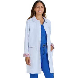 A light blue lab coat with floral trim, worn by a woman, featuring buttons and side pockets.