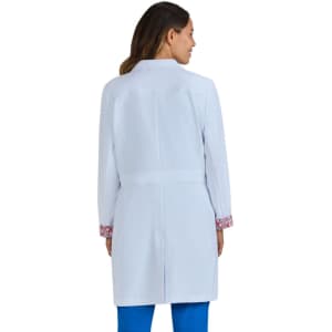 A white lab coat with patterned sleeves, featuring a fitted design and a back vent. It has a logo on the front.