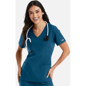 A woman wearing a teal women's double V-neck top with a stethoscope around her neck, featuring pockets and a logo.