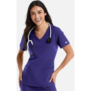 A woman wearing a purple double V-neck top with a stethoscope around her neck and pockets on the front.