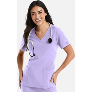 A lavender women's double V-neck top with short sleeves, featuring two front pockets and a stethoscope.
