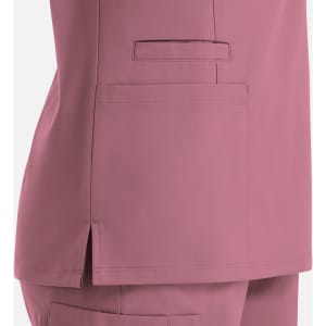 A women's double V-neck top in a soft pink shade, featuring a side pocket and split hem detail.