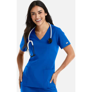 A woman in a bright blue, short-sleeved double V-neck top with a stethoscope around her neck, smiling.