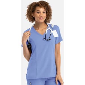 A women's mock wrap top in light blue, featuring a V-neckline and a stethoscope draped around the neck.