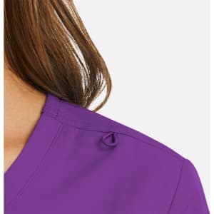A purple women's mock wrap top featuring a neckline detail and a subtle logo.
