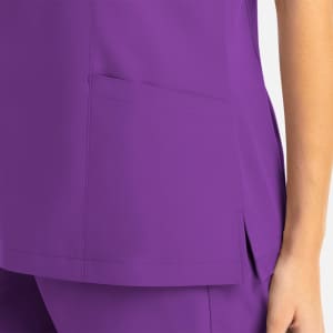A purple mock wrap top featuring a pocket and a side slit detail. The fabric appears smooth and lightweight.