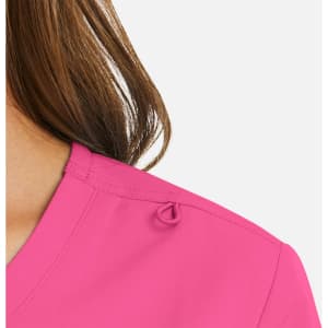 A close-up of a women's mock wrap top in bright pink, featuring a detail on the shoulder.