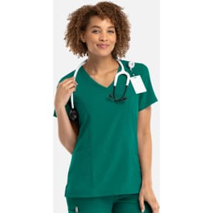 A women's mock wrap top in a vibrant teal colour with a stethoscope around the neck and a tag attached.