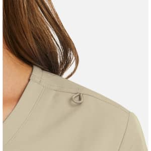 A women's mock wrap top in a beige tone, featuring a decorative loop detail on the shoulder.