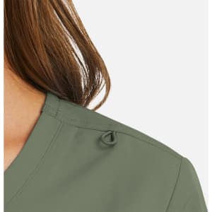A mock wrap top in a soft green colour, featuring a loop detail at the shoulder and a v-neck design.