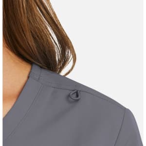 A close-up of a women's mock wrap top in grey, featuring a decorative loop detail on the shoulder.