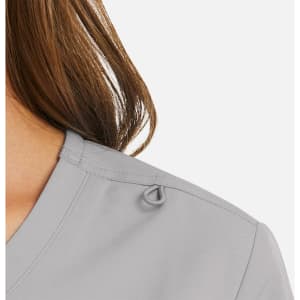 A grey mock wrap top with a subtle loop detail on the shoulder, showcasing soft fabric and neckline.