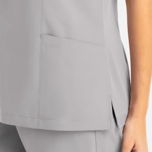 A grey women's mock wrap top featuring a side pocket and a slight slit at the hem. The fabric appears smooth and tailored.