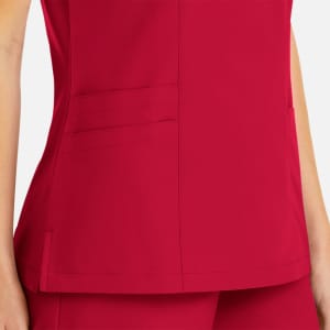 A close-up view of a women's mock wrap top in vibrant pink, featuring pockets and a sleek design.