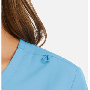 A close-up of a light blue women's mock wrap top, featuring a loop detail at the collar.
