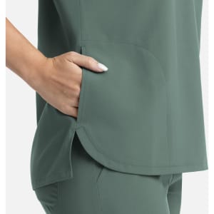 A green women's top featuring a dolman sleeve design and a side pocket. The fabric has a smooth finish.