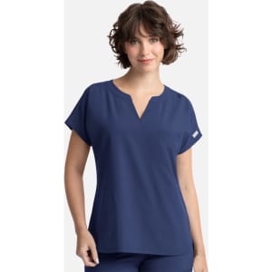 A women’s navy blue top featuring dolman sleeves and a pocket, with a logo on the side.
