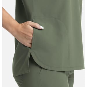 A green women's top featuring a dolman style and three pockets on the sides.