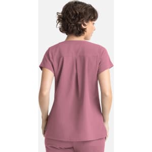 A women's top in a soft mauve colour with short sleeves and a pleat detail at the back. Features a logo.