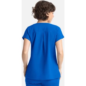 A blue women's Dolman top featuring three pockets, shown from the back on a model with curly hair.