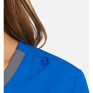 A vibrant blue mock wrap top featuring a contrast grey trim and a decorative detail on the shoulder.
