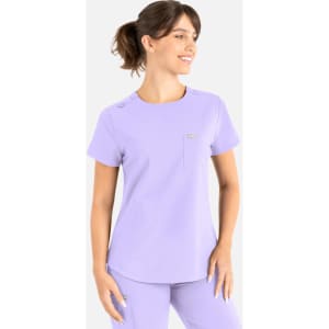 A purple round neck scrub top with a pocket, featuring a small logo and short sleeves.