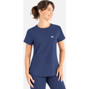 A navy blue round neck top designed as part of scrubs, featuring a pocket and a brand logo.