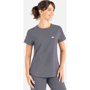A grey round neck scrub top with short sleeves and a pocket, featuring a logo on the chest.